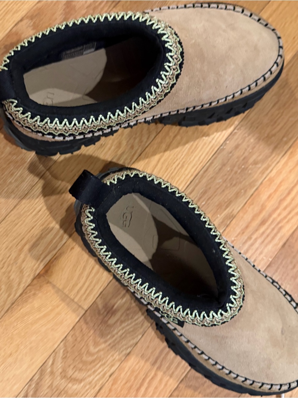 UGG Tan Suede Slip-On Shoes with Black Collar and Decorative Stitching